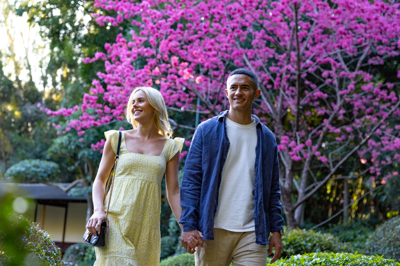 Close up image of a couple enjoying the views of an outdoor garden at Mt Coot-Tha Botanical Gardens.