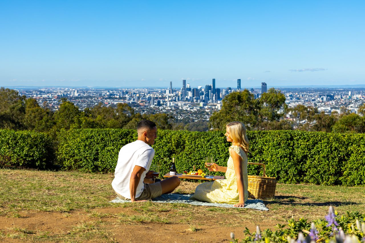 A couple having a picnic on the top of Mount Coot-tha