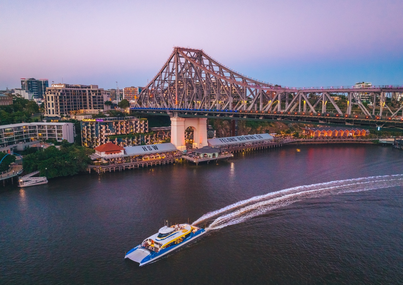 An aerial image of the Storey Bridge, Howard Smith Wharves and the Brisbane river at sunset.