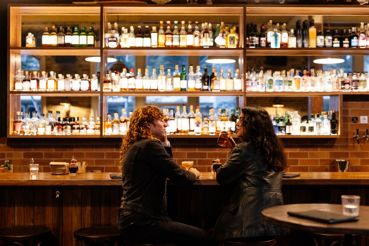 Image of two people sitting at bar, Frogs Hollow Saloon.