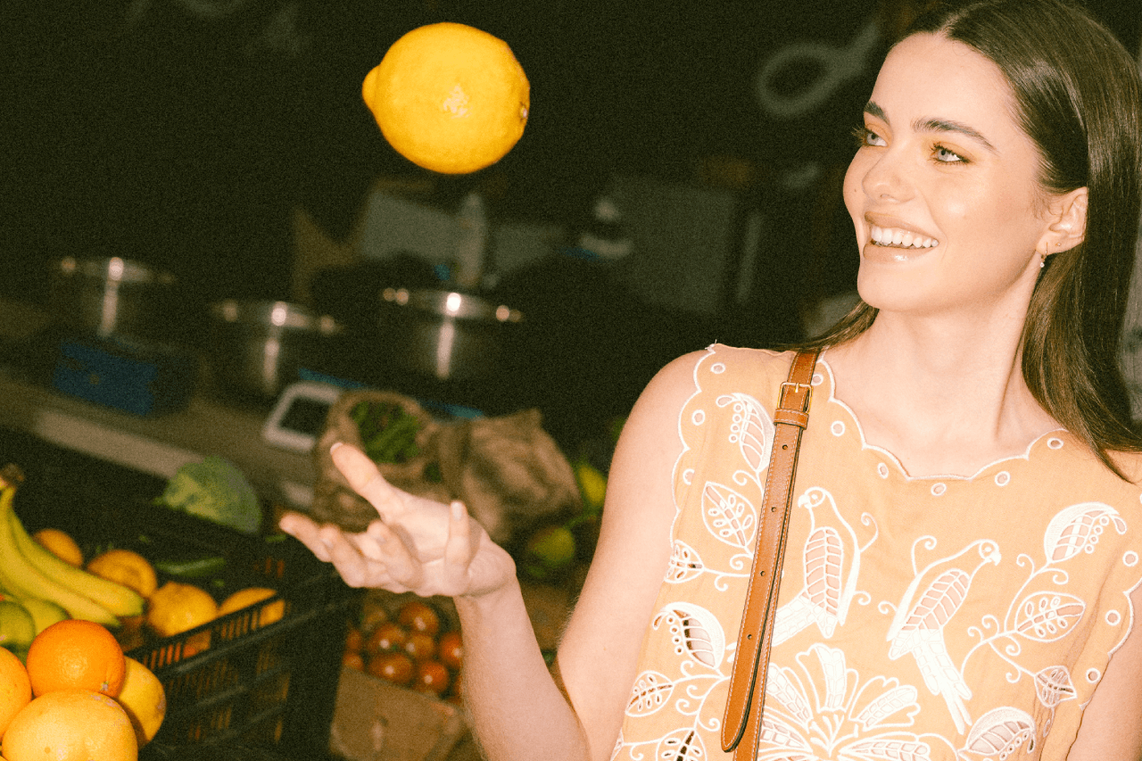 Girl with a fresh orange at Brisbane City Markets