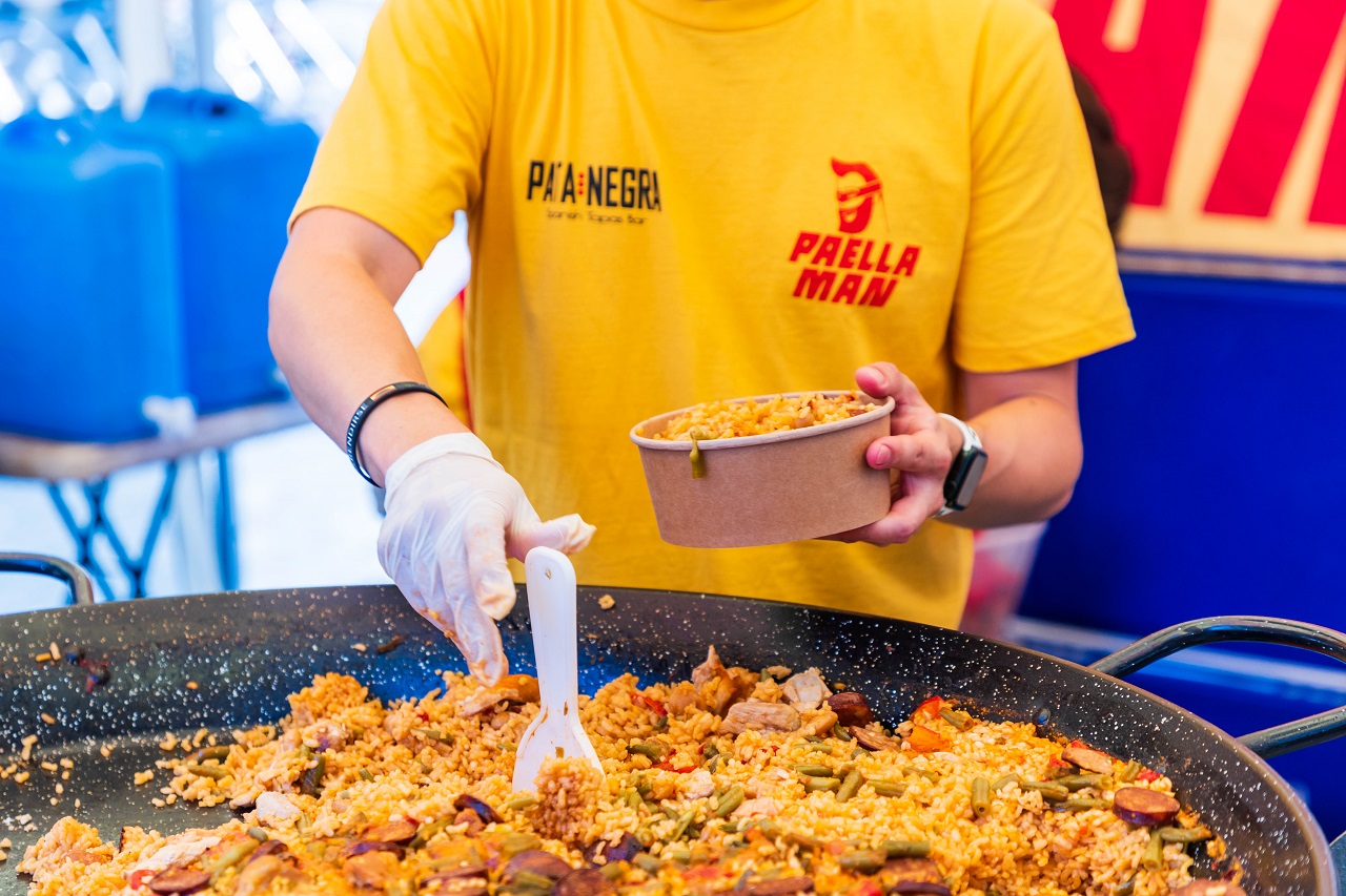 An image of Paella Man cooking seafood rice.