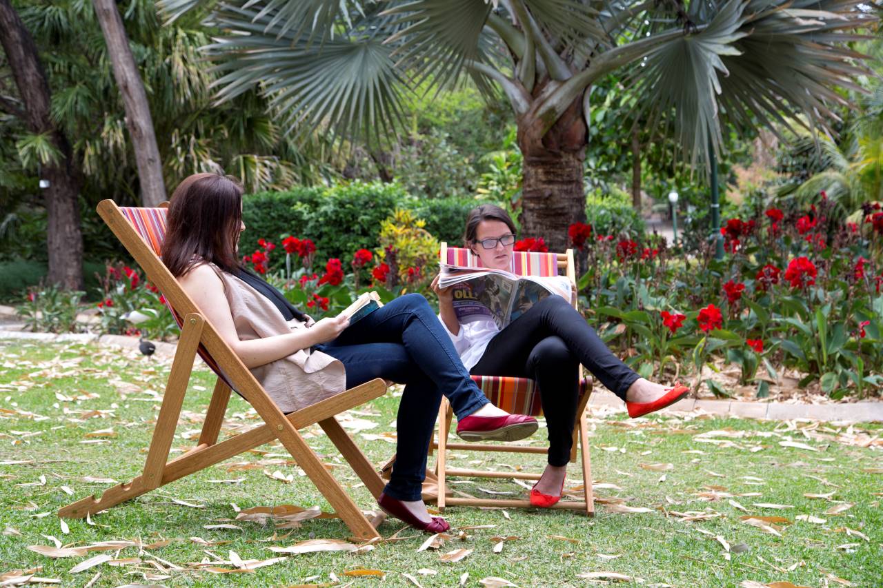 An image of two people sitting at Chair2share at the City Botanic Gardens.