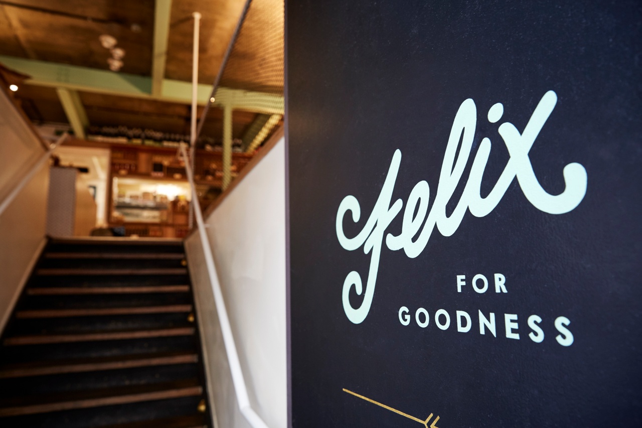 An image of Felix For Goodness sign at the entrance and stairs leading up to the café.