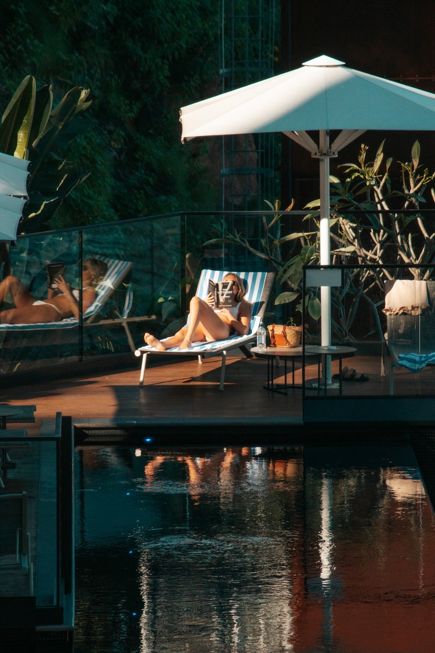 Woman relaxing poolside at Crystalbrook Vincent. 