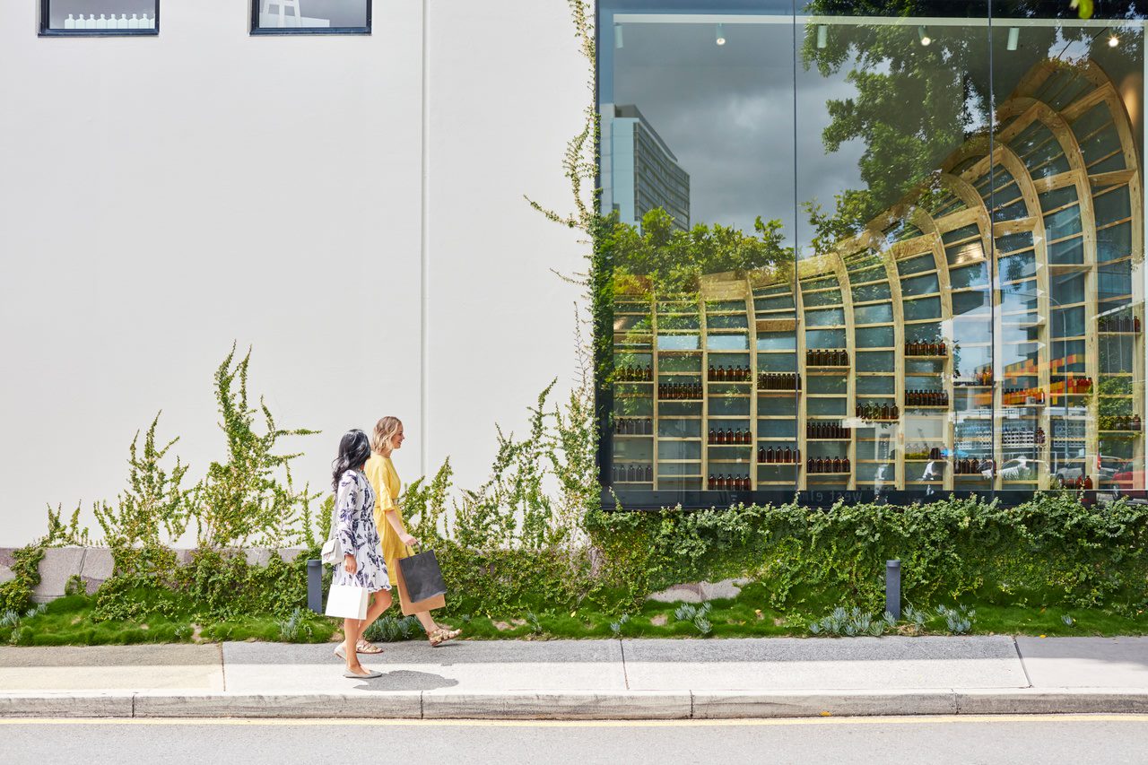 Two women strolling past shops on James Street