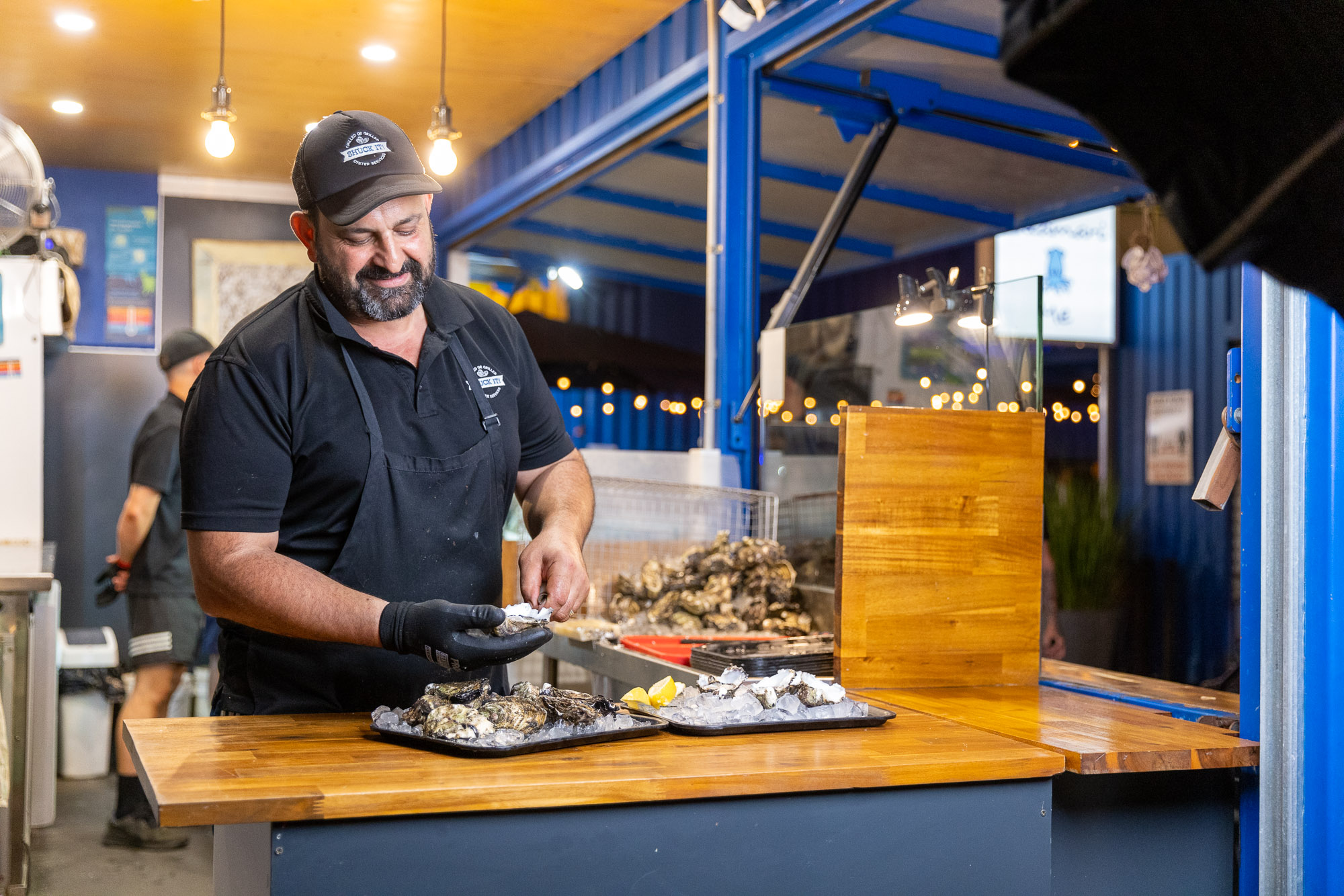 An image of chef shucking oysters.