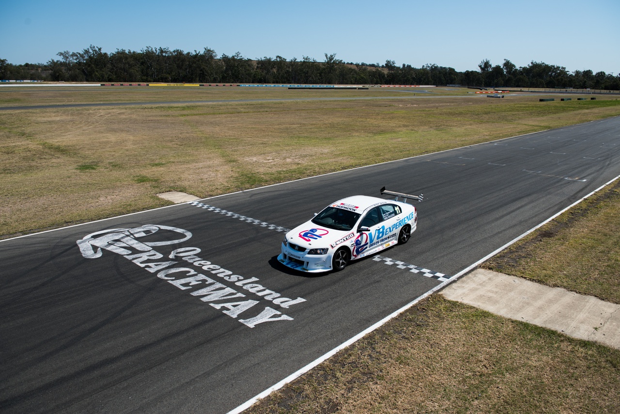 A V8 racing car racing on a course at Willowbank raceway, Ipswich.