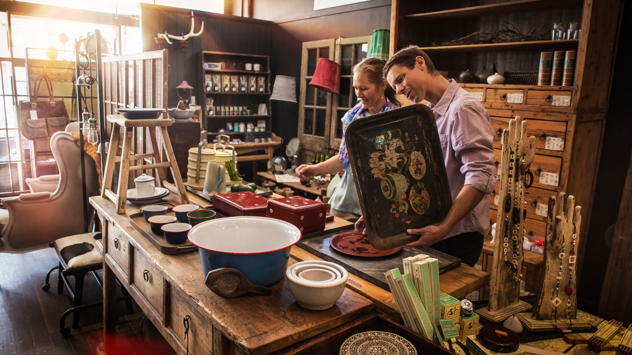Two people checking out products at an antique shop.