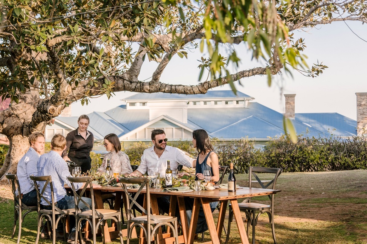 An image of a group of people sitting outdoors at a restaurant table at Spicers.
