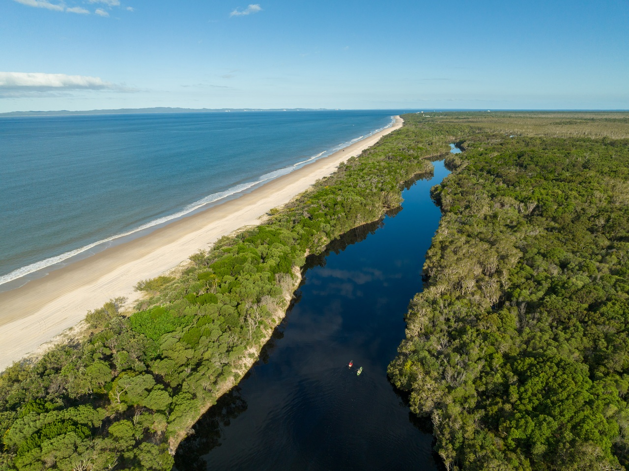 An aerial image of an island creek and the Bribie Island coastline