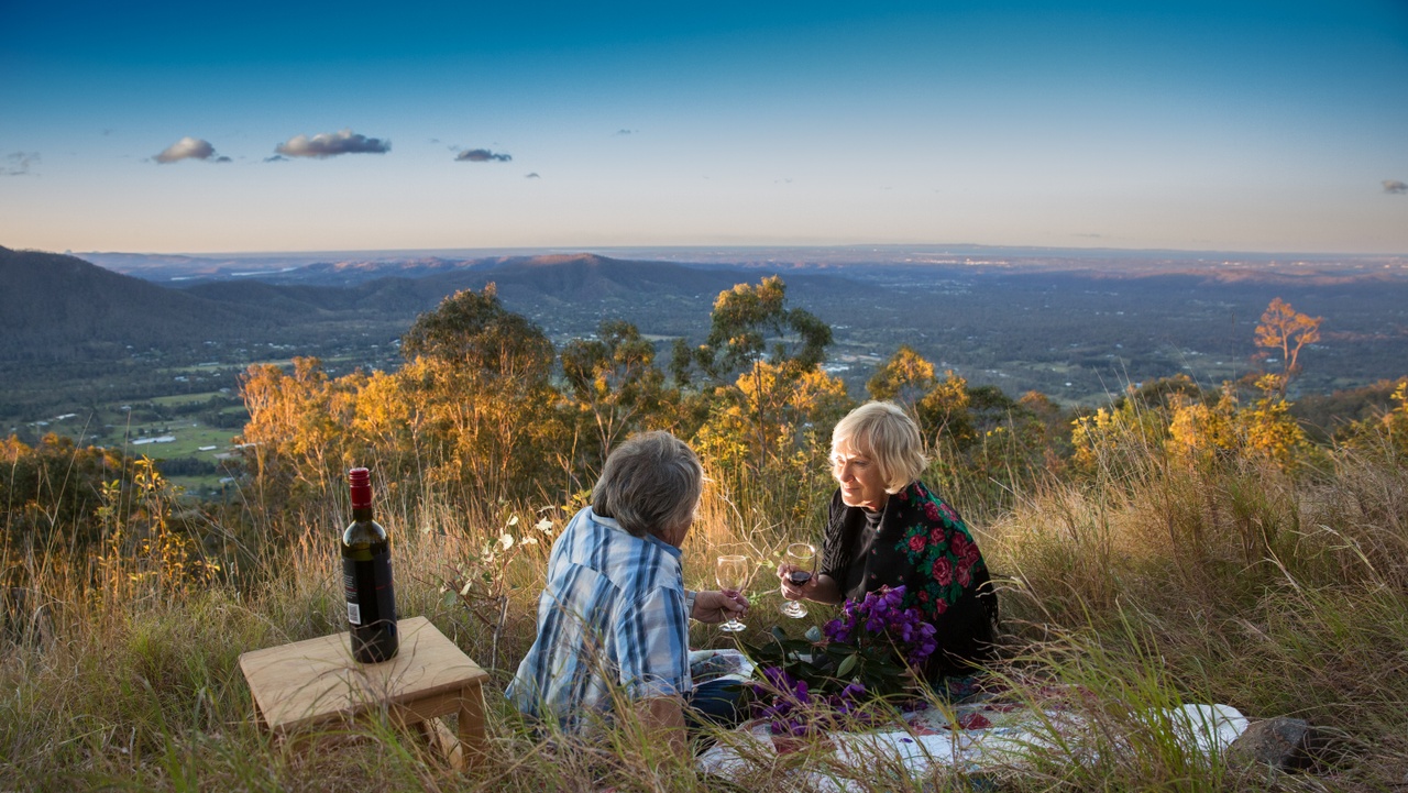 An image of a mature couple having a drink at Jollys Lookout at Moreton Bay Region.