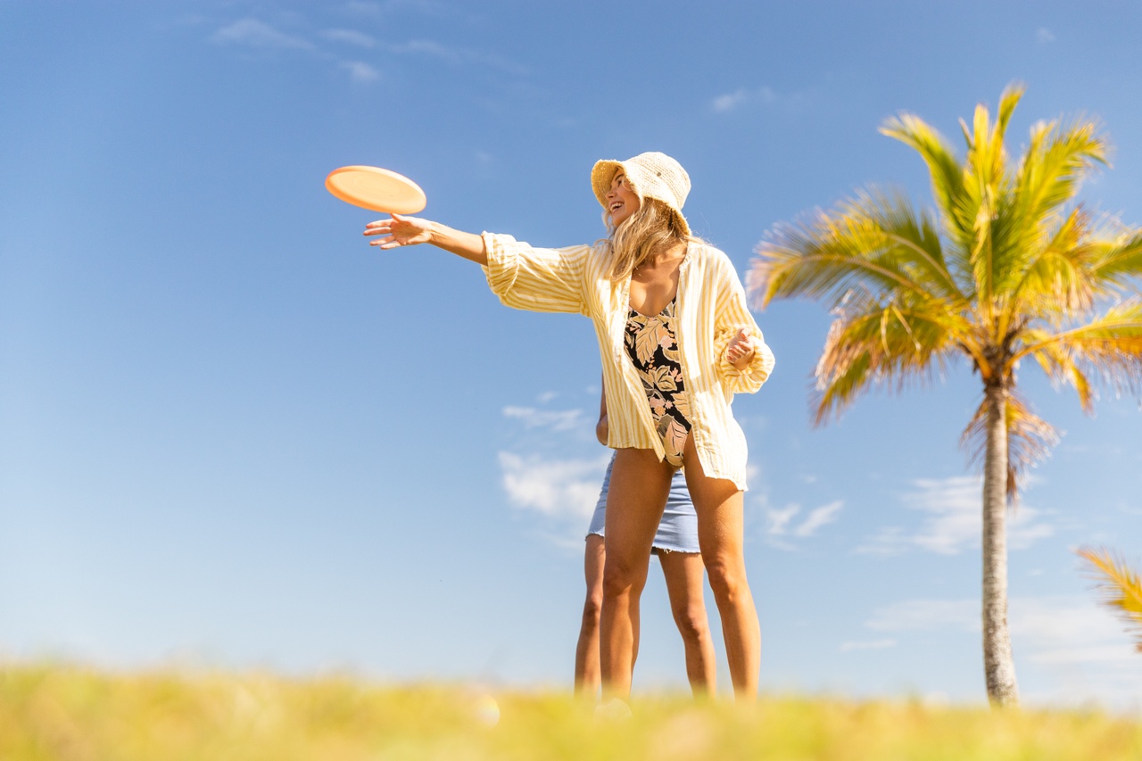 An image of a woman catching a frisbee at Tangalooma, Moreton Island.