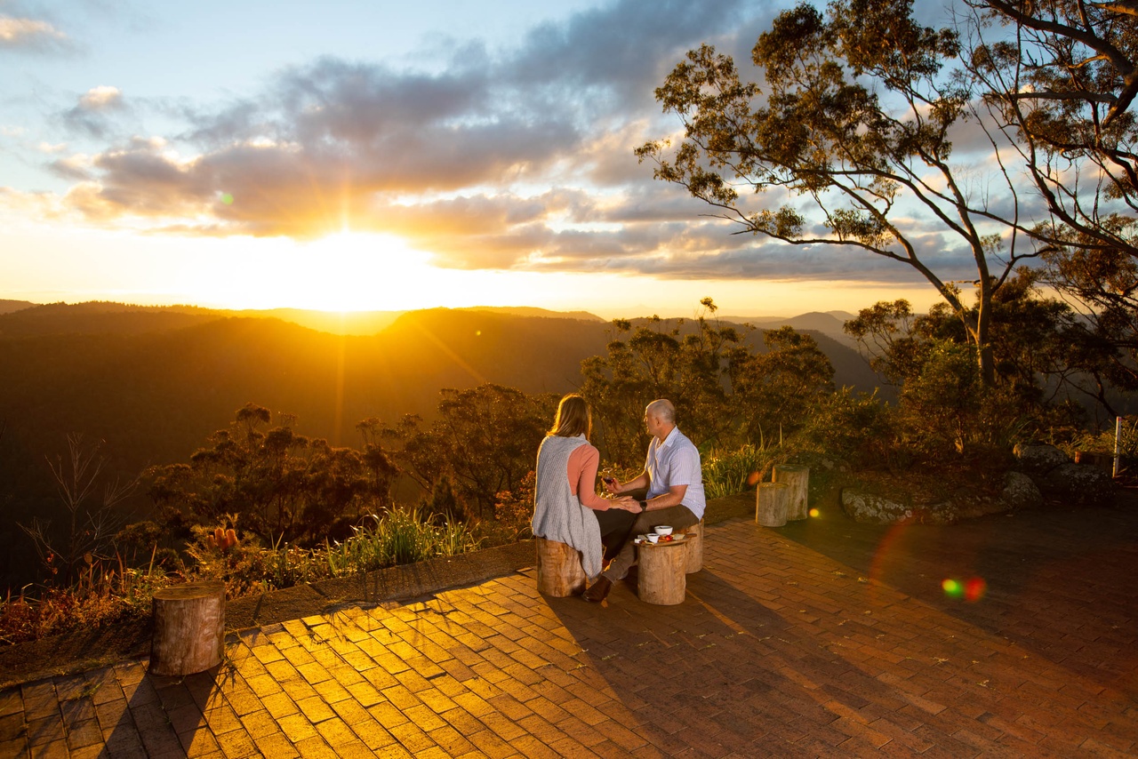 A mature couple viewing sunset in mountain at Binna Burra Lodge.