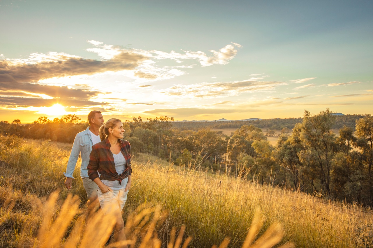 A couple enjoying views in sunset on hill at Spicers Hidden Vale.